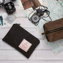 Load image into Gallery viewer, small olive green waxed canvas zipper pouch on the desk with a vintage compass, dopp kit and camera