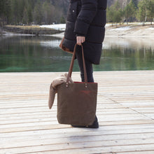 Load image into Gallery viewer, woman holding a large waxed canvas tote bag
